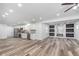 Open floor plan featuring the kitchen and living area, offering a fireplace with marble tile accent wall at 650 S Lyons Ave, Indianapolis, IN 46241