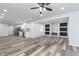 Open floor plan with fireplace and marble tile accent wall, connecting living room and kitchen at 650 S Lyons Ave, Indianapolis, IN 46241