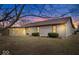 Backyard at dusk with a sunroom, showcasing the home's exterior and outdoor living space at 7326 Caboose Ct, Indianapolis, IN 46256