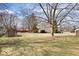 Spacious backyard with a shed, landscaping, and mature trees, offering a serene outdoor setting at 7326 Caboose Ct, Indianapolis, IN 46256