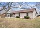 The home's backyard and exterior with a sunroom, showcasing landscaping and the outdoor living space at 7326 Caboose Ct, Indianapolis, IN 46256
