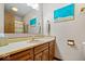 Bathroom featuring a single sink vanity, a mirror, and beach themed wall decorations at 7326 Caboose Ct, Indianapolis, IN 46256
