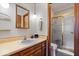 Bathroom featuring a single sink vanity, toilet, and tiled shower with glass doors at 7326 Caboose Ct, Indianapolis, IN 46256