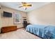 Bedroom featuring a ceiling fan, light-filled window, desk, and wood dresser at 7326 Caboose Ct, Indianapolis, IN 46256
