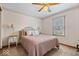 Bedroom featuring a ceiling fan, window for natural light, and a matching bedside table set at 7326 Caboose Ct, Indianapolis, IN 46256