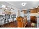 Kitchen featuring an island, bar seating, stainless steel appliances, and light fixtures at 7326 Caboose Ct, Indianapolis, IN 46256