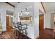 View from bar to a modern kitchen with warm wood cabinets and sleek countertops, perfect for entertaining at 7326 Caboose Ct, Indianapolis, IN 46256