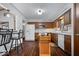 Well-lit kitchen with stainless steel appliances, an island, and wood-look flooring at 7326 Caboose Ct, Indianapolis, IN 46256