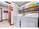 Laundry room featuring a washer, dryer, shelving, and tiled floors at 7326 Caboose Ct, Indianapolis, IN 46256