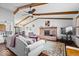 Inviting living room with vaulted ceilings, exposed wood beams, a brick fireplace, and stylish furniture at 7326 Caboose Ct, Indianapolis, IN 46256