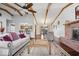 Open-concept living room boasts a brick fireplace, wood floors, vaulted ceilings, and seamless kitchen access at 7326 Caboose Ct, Indianapolis, IN 46256