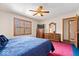 Bedroom features a ceiling fan, natural light, and traditional wood furniture at 7326 Caboose Ct, Indianapolis, IN 46256