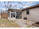 View of sunroom exterior from backyard with a patio and fence, highlighting the outdoor space at 7326 Caboose Ct, Indianapolis, IN 46256