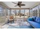 Bright sunroom featuring large windows, a ceiling fan, and comfortable seating, perfect for relaxing and enjoying the view at 7326 Caboose Ct, Indianapolis, IN 46256
