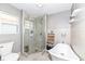 Bright bathroom with a glass-enclosed shower, standalone tub, and built in shelving at 764 E 42Nd St, Indianapolis, IN 46205
