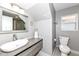 Updated bathroom featuring a modern vanity with a sleek sink, gray walls, and a decorative mirror at 764 E 42Nd St, Indianapolis, IN 46205