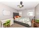 Bedroom with a green chair, a gray headboard, and natural light at 764 E 42Nd St, Indianapolis, IN 46205