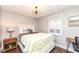 Cozy bedroom with large window, a nightstand, and a work space at 764 E 42Nd St, Indianapolis, IN 46205