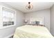 Cozy bedroom with large window and modern lighting fixture at 764 E 42Nd St, Indianapolis, IN 46205