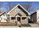 Charming two-story home featuring unique architectural details and a well-maintained front yard with wrought iron fence at 764 E 42Nd St, Indianapolis, IN 46205