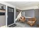 Charming front porch featuring stylish lighting, a welcoming doormat, and comfortable wicker chairs at 764 E 42Nd St, Indianapolis, IN 46205