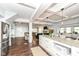 Open-concept kitchen with granite counters and stainless refrigerator flows into living room at 764 E 42Nd St, Indianapolis, IN 46205