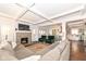 Open-concept living room with coffered ceilings, a fireplace, and seamless flow into the kitchen and dining areas at 764 E 42Nd St, Indianapolis, IN 46205