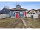 Back of home features two red doors, a yard and access to alley at 832 N Parker Ave, Indianapolis, IN 46201