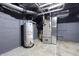 Basement with gray walls, speckled floor, and mechanicals at 832 N Parker Ave, Indianapolis, IN 46201