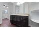 Bathroom with a double vanity, a large mirror, and wood flooring at 832 N Parker Ave, Indianapolis, IN 46201