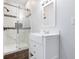 Modern bathroom featuring a glass-enclosed shower and vanity with a sink at 832 N Parker Ave, Indianapolis, IN 46201