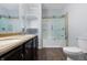 Bathroom featuring updated fixtures, open shelving, and a shower with glass doors at 832 N Parker Ave, Indianapolis, IN 46201