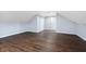 Cozy bedroom featuring hardwood floors, slanted ceilings, and ample closet space at 832 N Parker Ave, Indianapolis, IN 46201