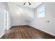 Bedroom featuring hardwood floors, slanted ceilings, and natural light from the window at 832 N Parker Ave, Indianapolis, IN 46201