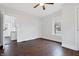 Bedroom featuring hardwood floors, a window, and a doorway to another room at 832 N Parker Ave, Indianapolis, IN 46201