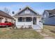 Charming blue two-story home featuring a welcoming front porch and landscaped yard at 832 N Parker Ave, Indianapolis, IN 46201