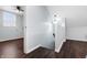 Hallway with hardwood floors, a pendant light, and staircase leading to other areas at 832 N Parker Ave, Indianapolis, IN 46201