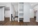 Spacious hallway featuring hardwood floors, staircase, and convenient built-in shelving at 832 N Parker Ave, Indianapolis, IN 46201
