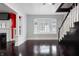 Open living room with bay window, hardwood floors, fireplace, and staircase at 832 N Parker Ave, Indianapolis, IN 46201