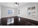 Light filled living room with new windows, ceiling fan, and refinished original hardwood floors at 832 N Parker Ave, Indianapolis, IN 46201