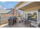 Cozy covered patio with outdoor seating, a grill, and a sliding glass door leading inside at 9046 Pinecreek Ct, Indianapolis, IN 46256