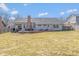 Backyard view with a large lawn, deck with outdoor furniture, mature trees, and a privacy fence at 9046 Pinecreek Ct, Indianapolis, IN 46256