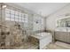Spa-like bathroom boasts a walk-in shower with glass enclosure, a soaking tub, and mosaic tile accents at 9046 Pinecreek Ct, Indianapolis, IN 46256