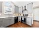 Contemporary kitchen showcasing gray cabinetry, stainless steel appliances, and stylish subway tile backsplash at 9046 Pinecreek Ct, Indianapolis, IN 46256
