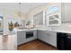 Well-lit kitchen with gray cabinetry, quartz countertops, stainless steel appliances, and a view to the outdoors at 9046 Pinecreek Ct, Indianapolis, IN 46256