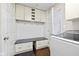 A convenient mudroom offers storage with a built-in bench, drawers, hooks, and cabinets for optimal organization at 9046 Pinecreek Ct, Indianapolis, IN 46256