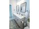 Bright bathroom features double sinks, gray cabinets, modern fixtures, and decorative accents at 9748 Junction Station, Fishers, IN 46037