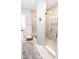 Well-lit walk-in shower with neutral tile, glass partition, and tile flooring at 9748 Junction Station, Fishers, IN 46037