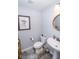 Well-lit half bathroom featuring modern fixtures, a pedestal sink, and stylish decor at 9748 Junction Station, Fishers, IN 46037