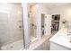Well-lit walk-in shower and view into a walk-in closet. Neutral tile throughout at 9748 Junction Station, Fishers, IN 46037